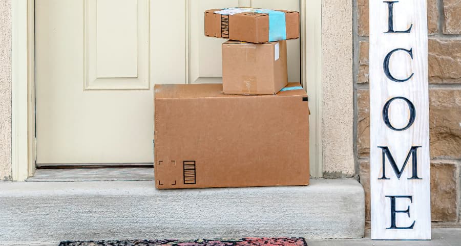 Packages on the doorstep of a home with a welcome sign in Yakima